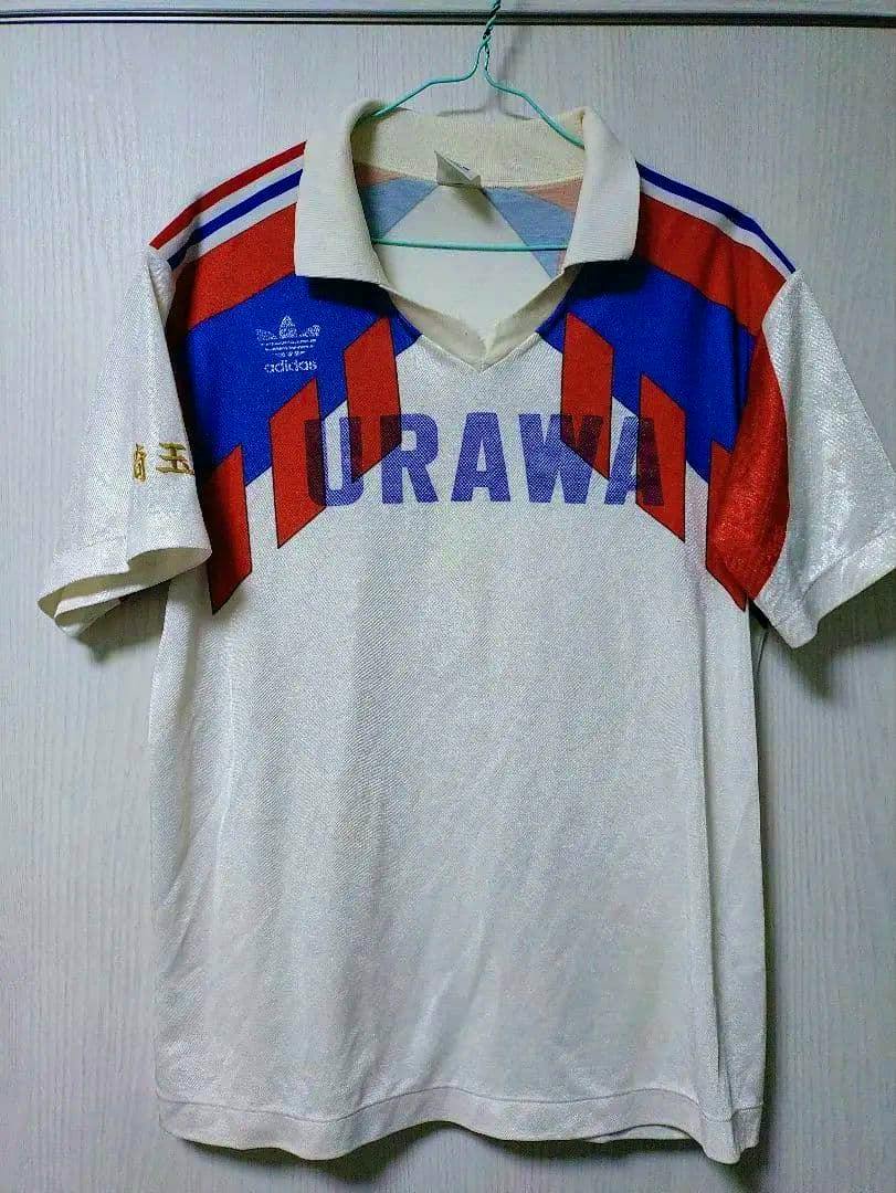 Front view of the Urawa High School soccer jersey showing 'URAWA' on the chest and red and blue shoulder graphics.