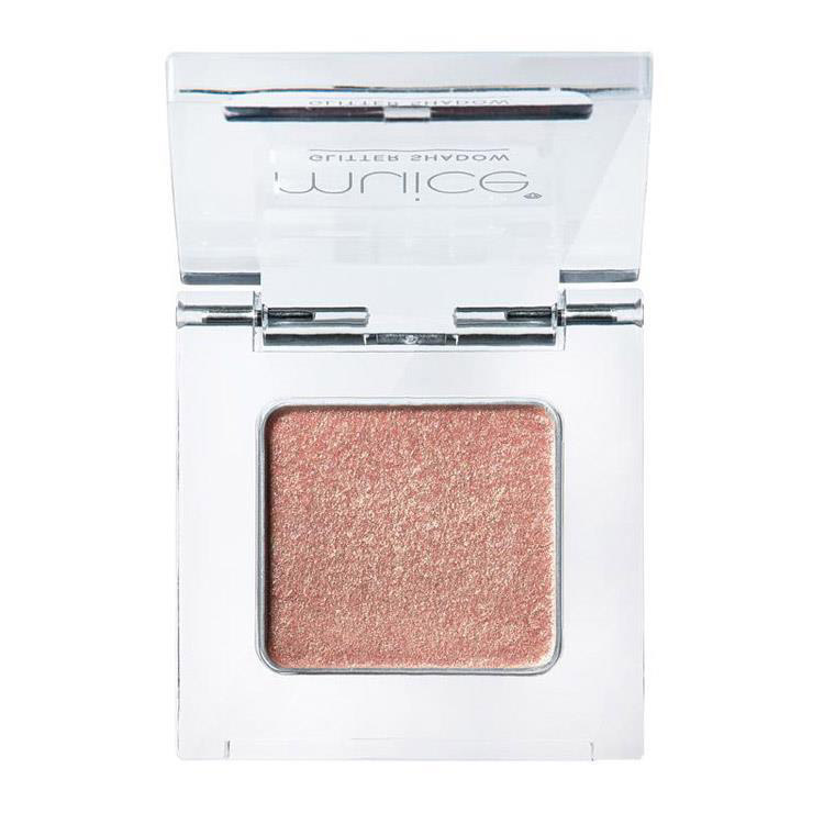 A single-pan eyeshadow in a clear square compact showing a shimmery crystal champagne shade.