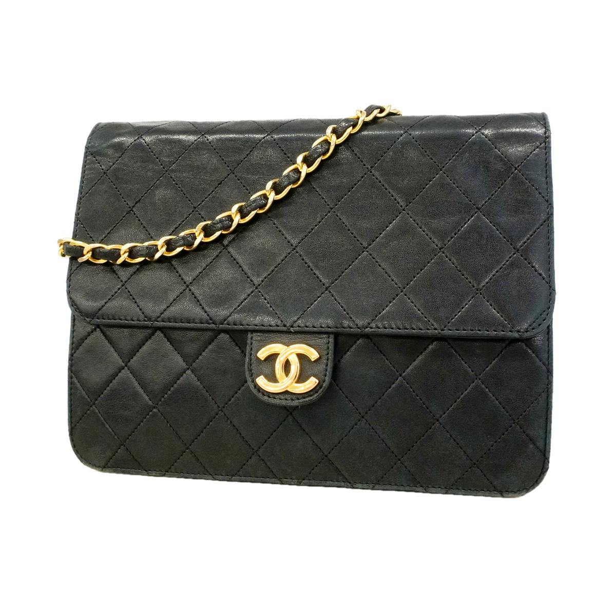 Front view of a used black lambskin quilted shoulder bag with a gold chain strap and a gold interlocking logo on the flap.