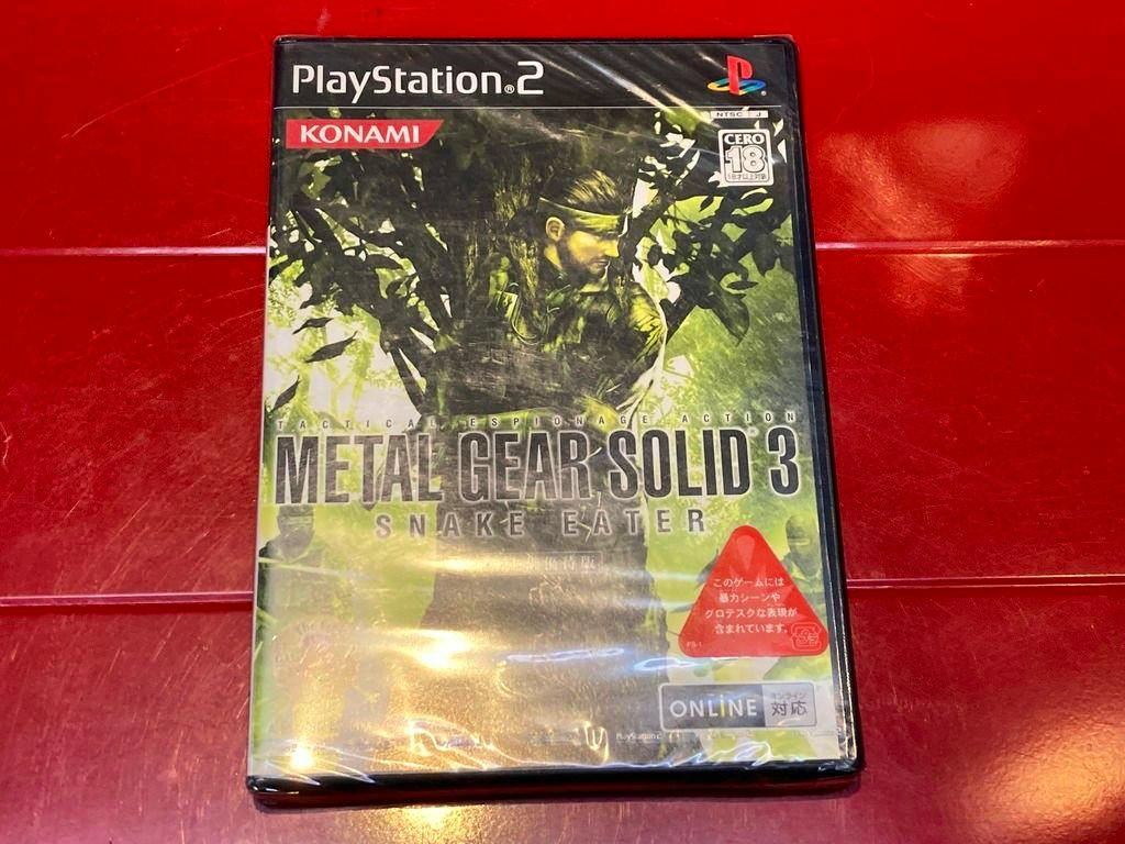Front cover of a PlayStation 2 game case for Metal Gear Solid 3: Snake Eater on a red surface.