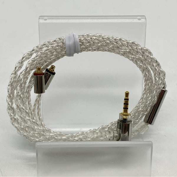 Coiled silver braided MMCX to 2.5mm 4-pole balanced audio cable displayed on a clear stand.