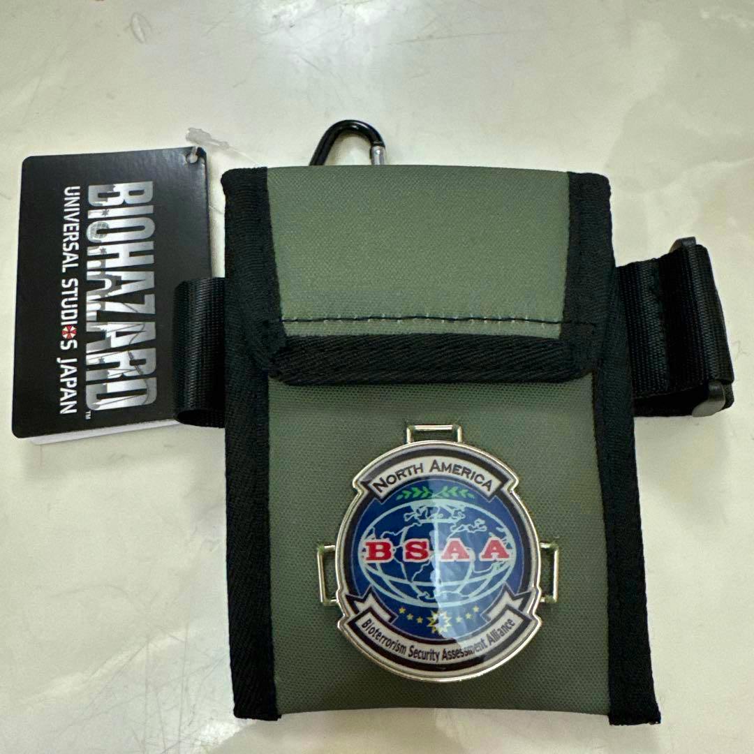 Front view of a green USJ Biohazard BSAA pouch showing a BSAA emblem and a BIOHAZARD Universal Studios Japan tag.