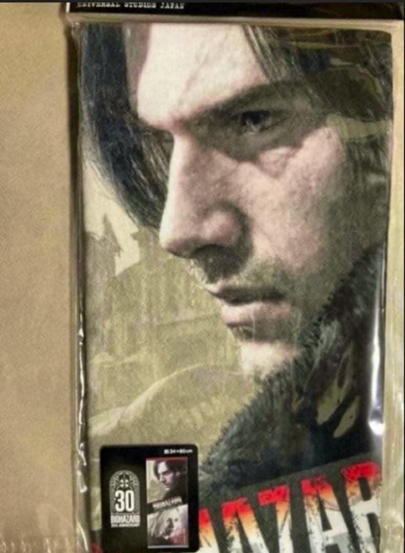 Packaged USJ-limited Biohazard face towel showing a close-up printed image of a man's face.