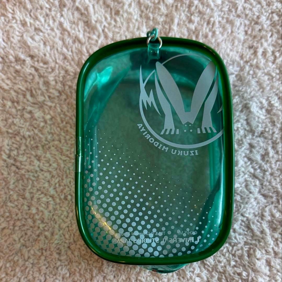 Green clear plastic USJ Izuku Midoriya (Deku) pouch showing the back side with a printed emblem and dotted pattern.