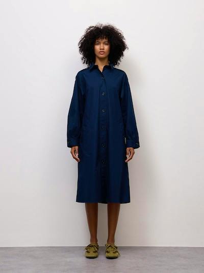 A model wearing a navy button-up cotton shirt dress standing facing forward against a plain light background.