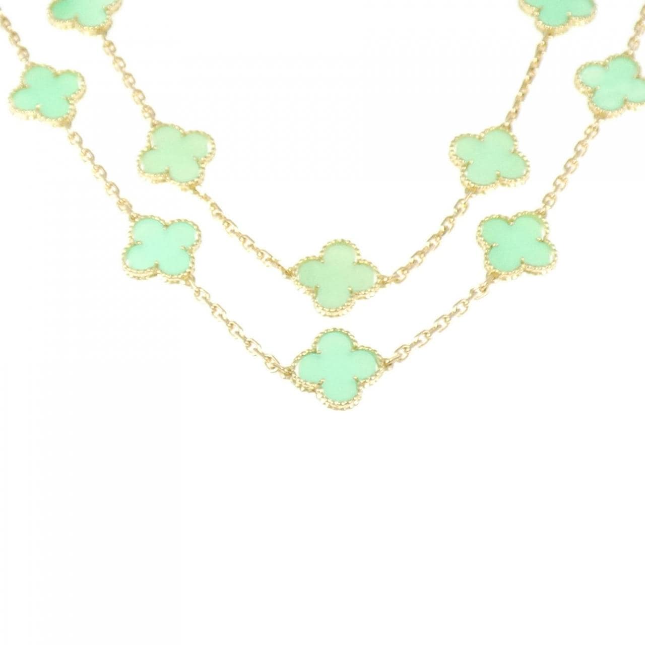 Gold necklace with multiple green clover-shaped motifs on a double chain, shown on a white background.