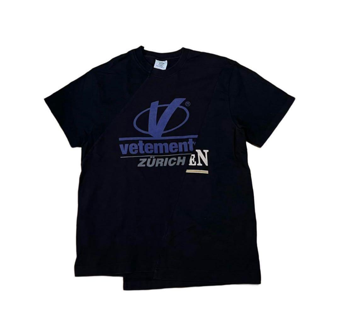 Flat-lay front view of a black Vetements logo T-shirt featuring a large graphic with "vetement" and "ZÜRICH".