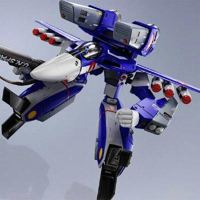Blue VF-1J Super Valkyrie plastic figure posed in a dynamic flight stance with visible missile pods and articulated limbs.