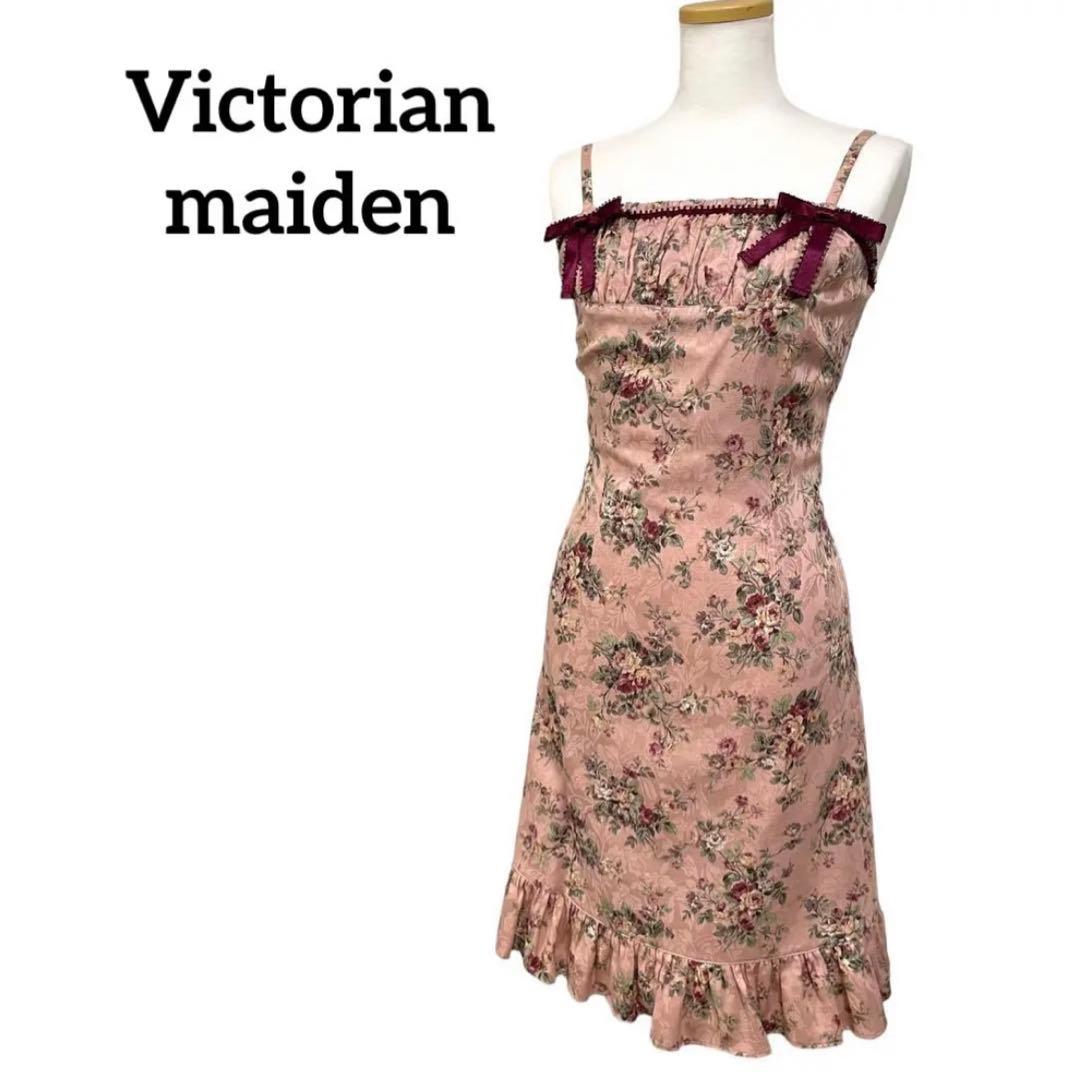 Pink rose-pattern Victorian Maiden sleeveless dress with ruffled hem and burgundy ribbon bows displayed on a mannequin.