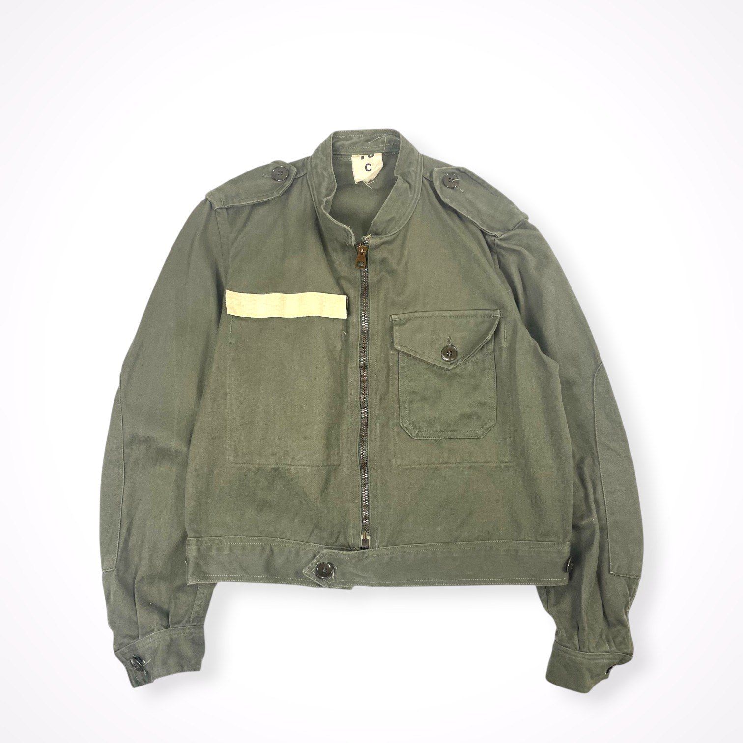 Vintage 70s French military men's cotton utility motorcycle jacket laid flat, green with central zipper and flap pocket.