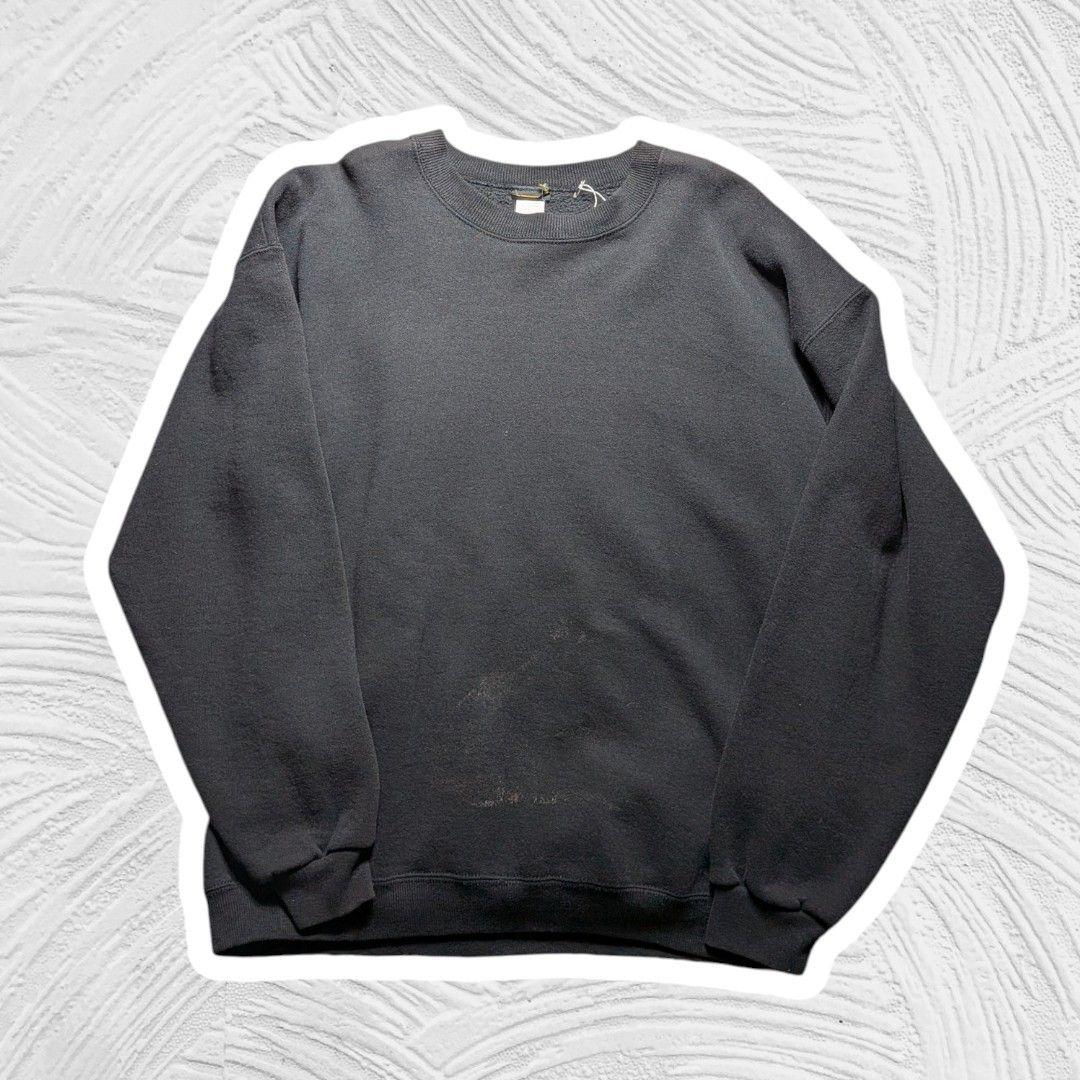 Front view of a vintage USA-made black polyester XL sweatshirt laid flat on a textured background.