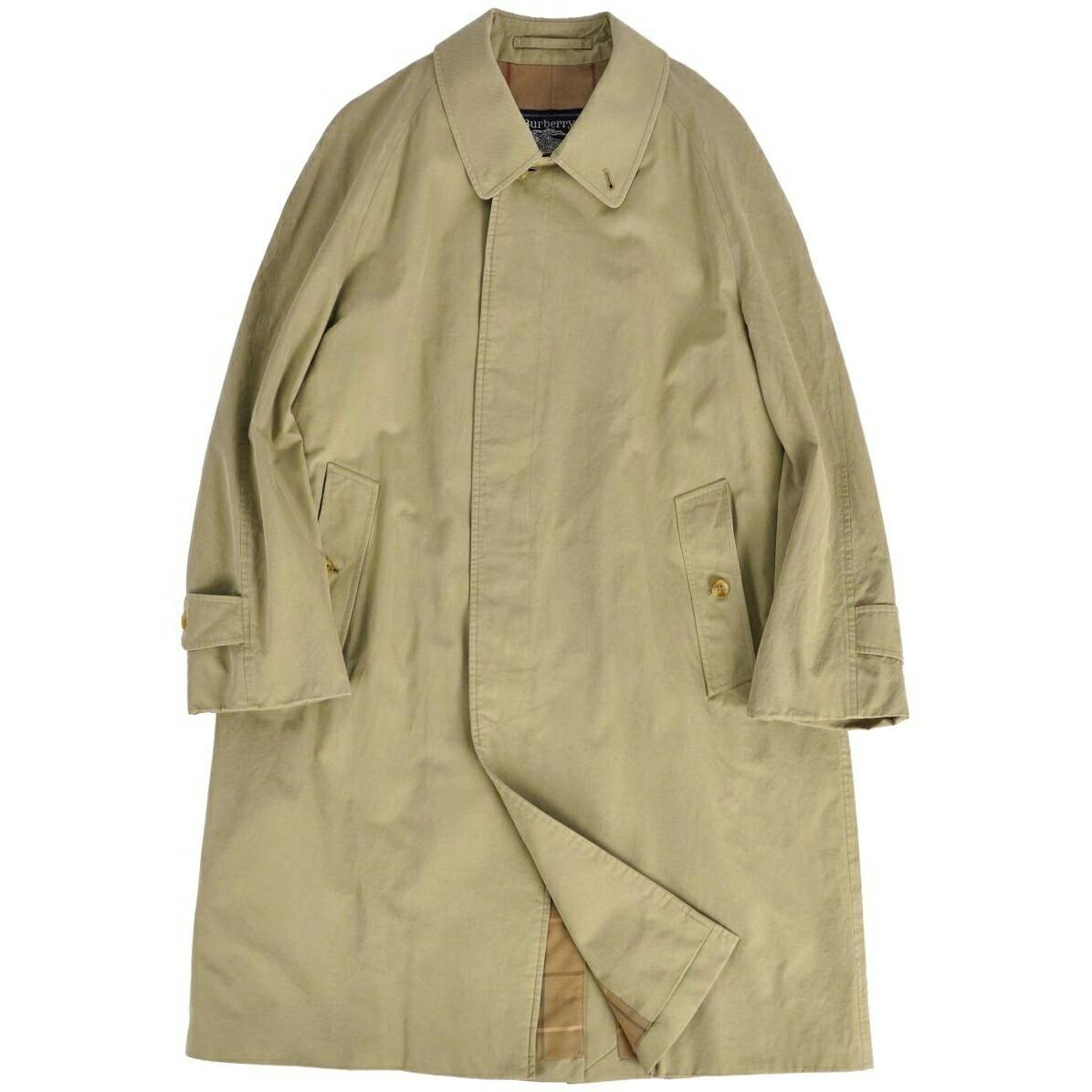 Beige Burberrys long coat (cotton) laid flat showing the front with pockets and a partial view of the checked lining.