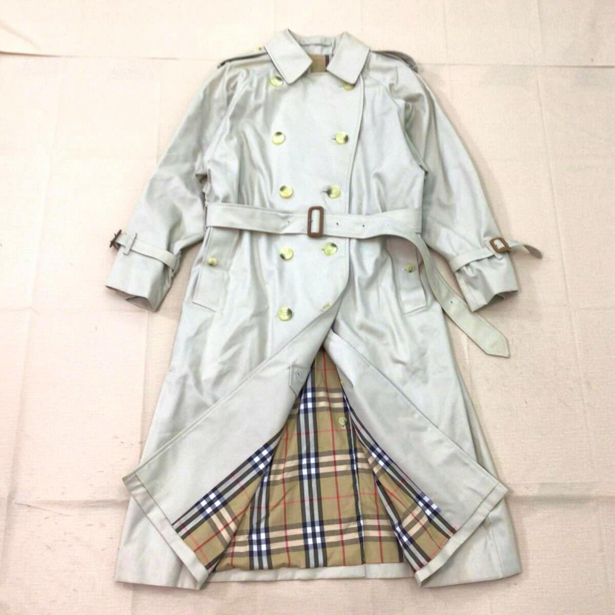 Laid-flat khaki Burberrys trench coat with belt, front view showing beige Nova check lining.