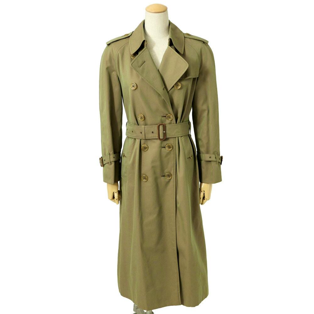 Long khaki double-breasted Burberry trench coat with belt displayed on a mannequin.