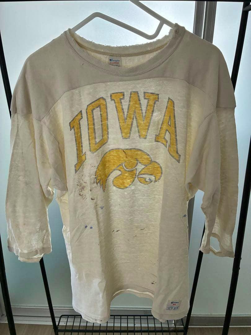 Front view of a vintage Champion IOWA cotton T-shirt (XL) with three-quarter sleeves, yellow logo, and visible stains and wear.