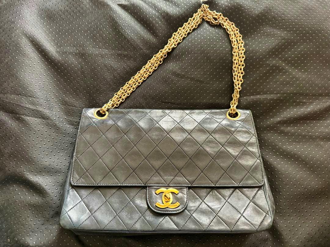 Front view of a vintage Chanel Matelassé lambskin shoulder bag with quilted diamond pattern, gold chain strap, and CC turn-lock.