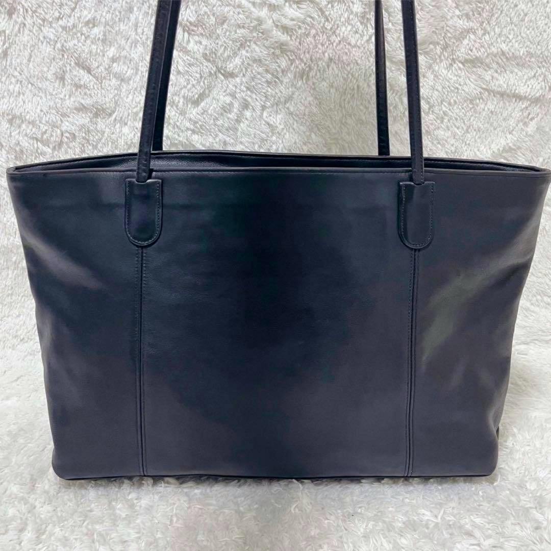 Front view of an Old Coach one-shoulder tote bag in glove-tan leather with two shoulder straps on a light textured background.