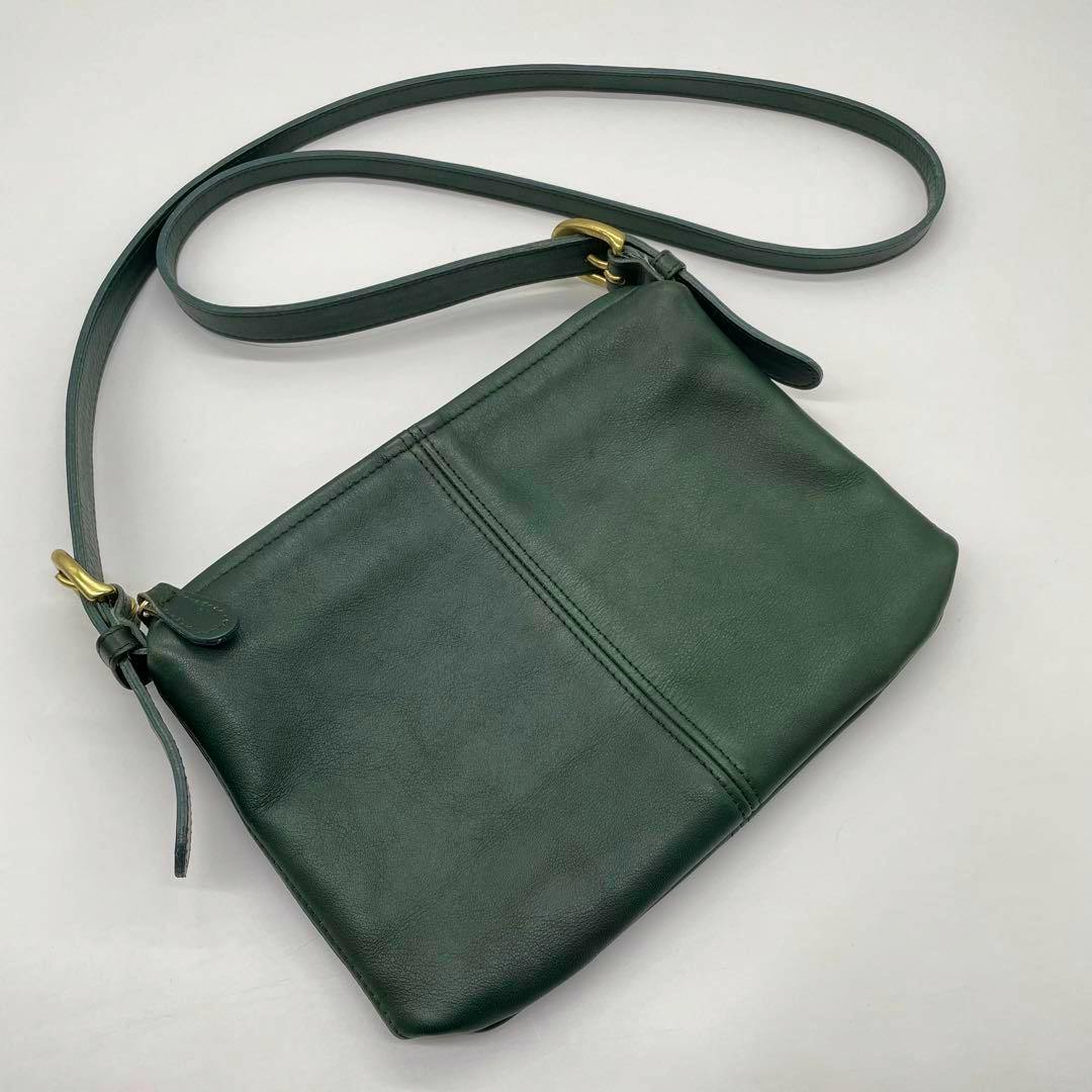 Green Coach 4130 leather shoulder bag laid flat on a white background showing the front and shoulder strap.