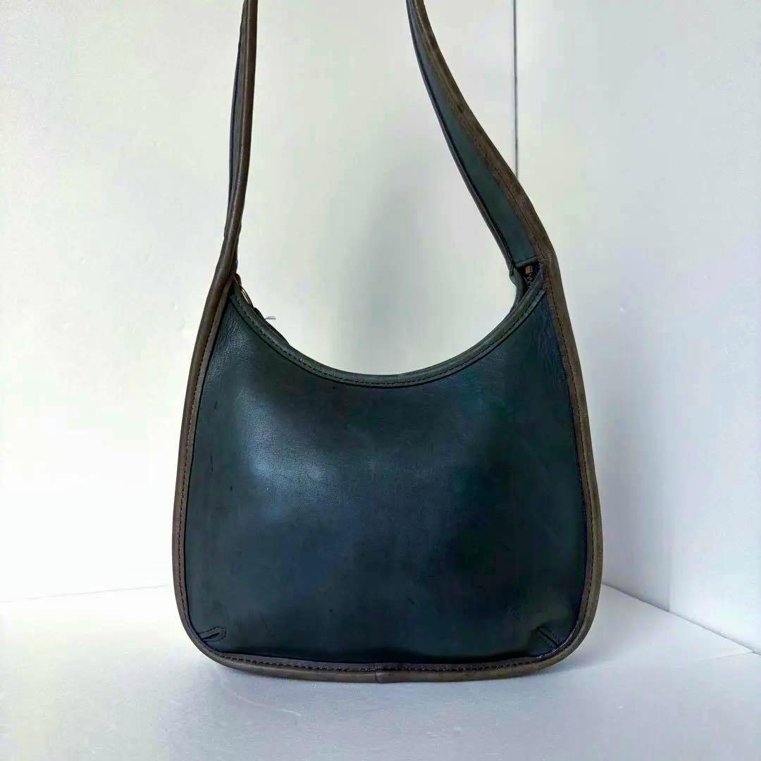 Front view of a blue cow leather Coach 9020 Ergo shoulder bag with brown trim and a single strap on a white background.