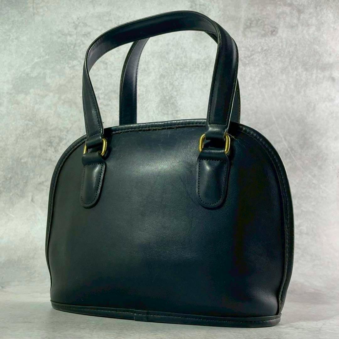 Black all-leather Coach handbag shown from the front with double handles and gold-tone hardware.