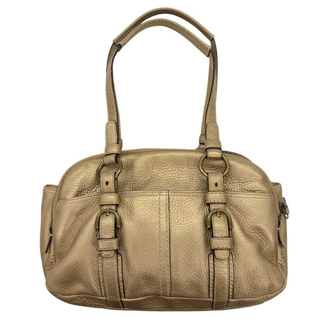Front view of the vintage Coach double-zip shoulder bag in gold cow leather with dual straps and buckle accents.