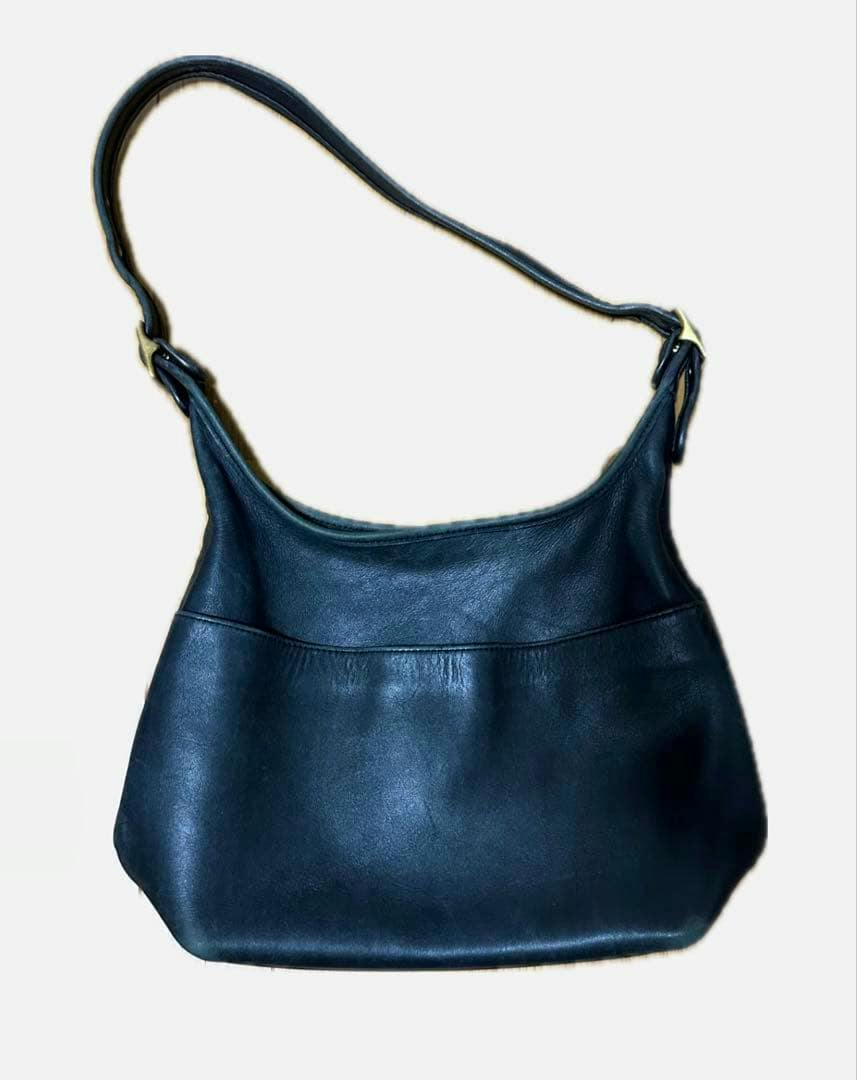 Front view of the OLD COACH cow leather shoulder bag laid flat showing the bag body and single shoulder strap.