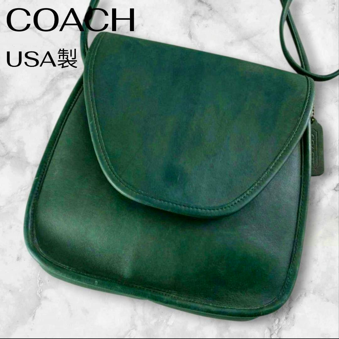 Green Coach cow leather shoulder bag with a front flap closure and a visible leather hang tag.