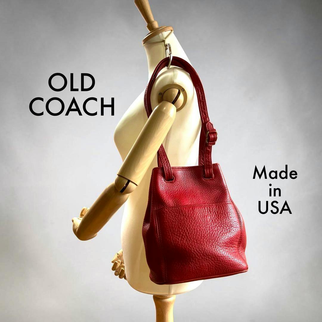 Red vintage Coach leather tote one-shoulder bag displayed on a mannequin.