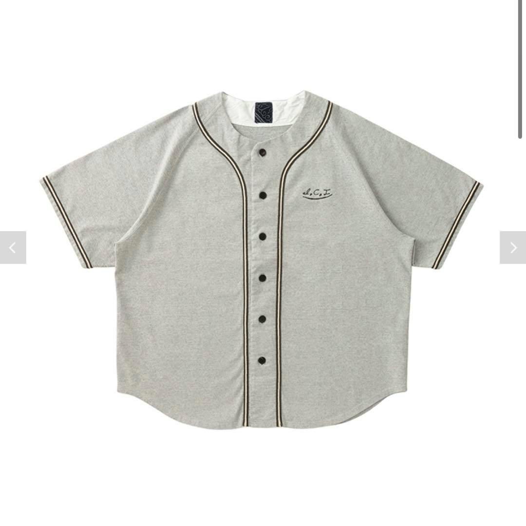 Charcoal short-sleeve men's button-up shirt with contrast piping laid flat on a white background.