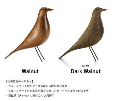 Two wooden Eames House Bird ornaments shown side by side in walnut and dark walnut finishes.