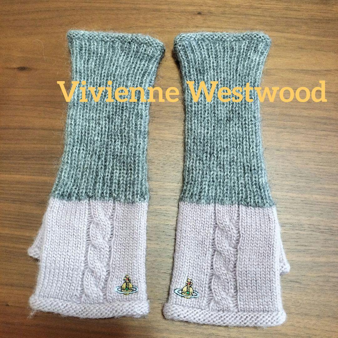 Two gray and pink cable-knit arm covers laid flat on a wooden surface with "Vivienne Westwood" text overlaid.