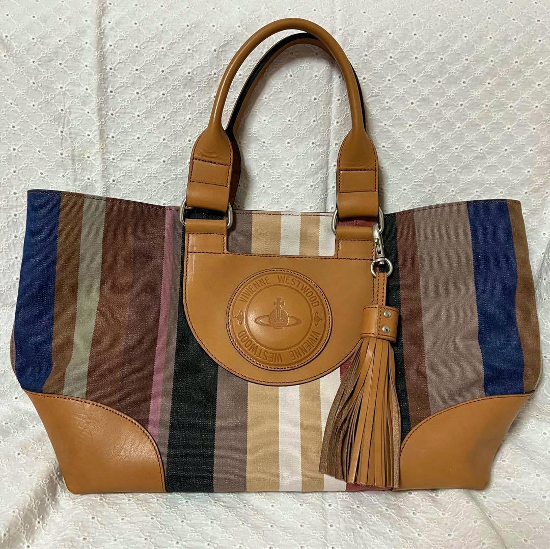 Canvas multi-stripe Vivienne Westwood tote bag with tan leather handles, embossed round logo patch and leather tassel.
