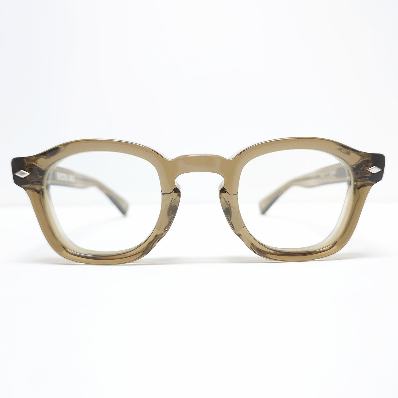 Front view of VOLTA KH glasses showing a translucent brown round frame on a white background.