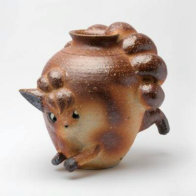 Photograph of a ceramic Shigaraki-style flower pot (M) shaped like a small animal with a curled tail, ears, and four stubby legs on a white background.