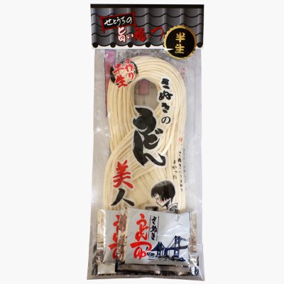 Clear plastic package containing hand-stretched semi-dried Sanuki udon noodles with two soup packets visible.