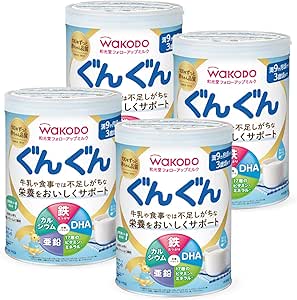 Four cans of Wakodo Follow Up Milk powder (9 months) with blue-and-white labels displayed together.