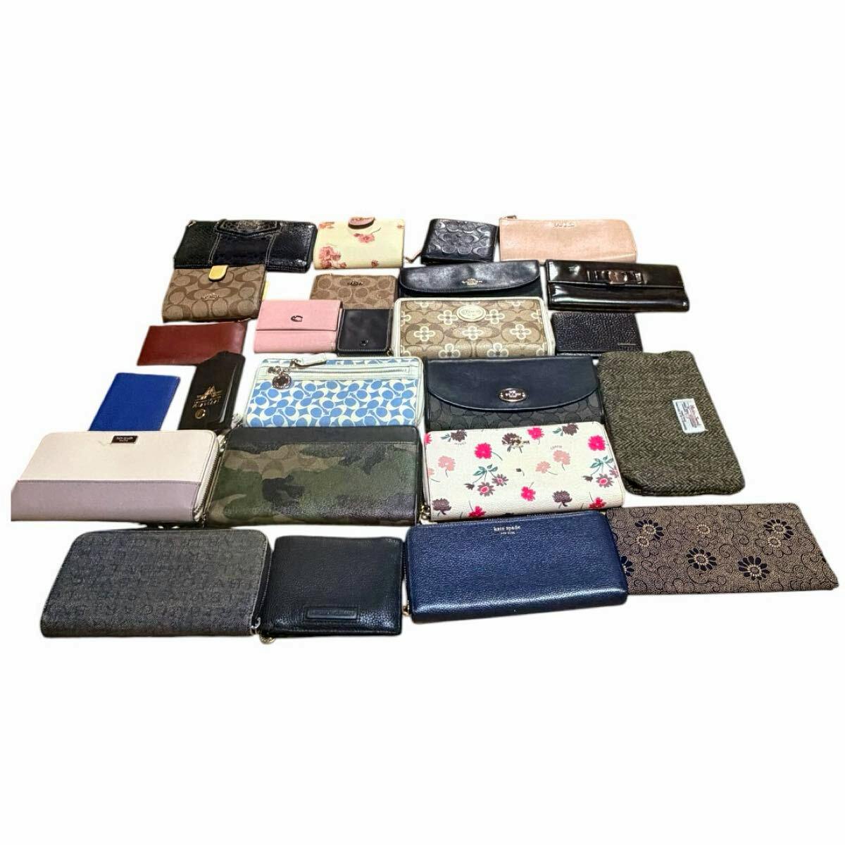 A large assortment of assorted wallets and small purses arranged in rows on a white background.