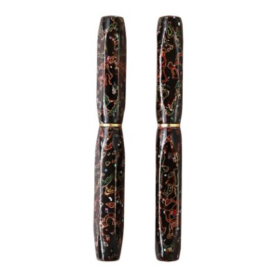 Two views of the WANCHER fountain pen with black Tsugaru lacquer and raden decoration on a wooden barrel.