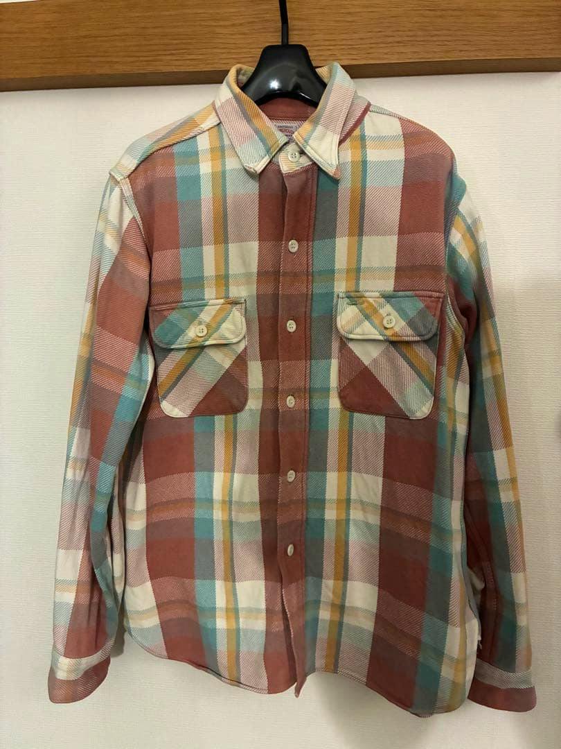 Front view of a men's long-sleeve WAREHOUSE check flannel shirt on a hanger.