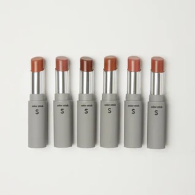 Five lip gloss sticks in gray tubes with caps removed showing warm shades arranged in a row on a white background.