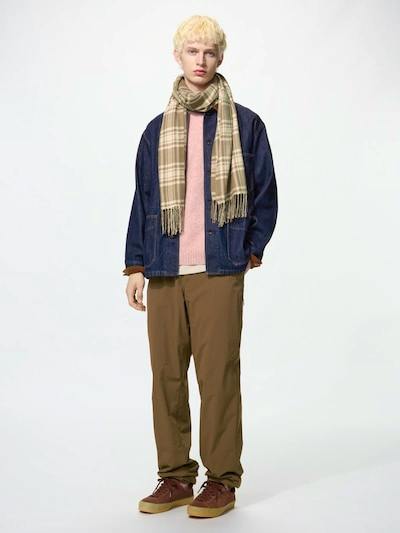 Male model wearing brown men's nylon pants standing against a white background.