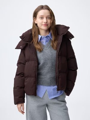 Model wearing the women's warm padded jacket layered over a shirt and sweater against a white background.
