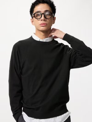 Model wearing a black crew-neck sweater.
