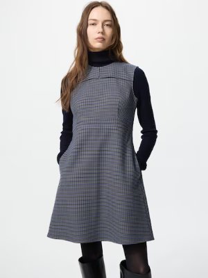 Model wearing the sleeveless knit dress shown on a female model.