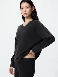 Model wearing a dark V-neck washable knit sweater shown in a three-quarter view.