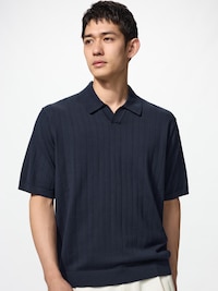 Male model wearing a dark short-sleeve skipper polo sweater, shown from the waist up.