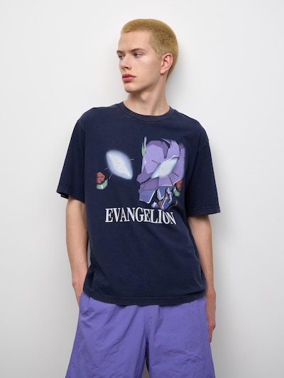 A model wears the navy washed cotton Evangelion graphic T-shirt showing the front print.