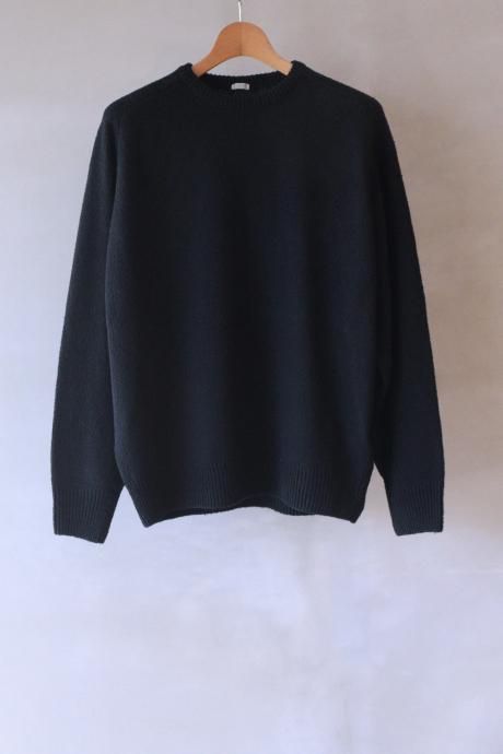 Washed Silk Nep crew neck sweater hanging on a wooden hanger against a plain background.