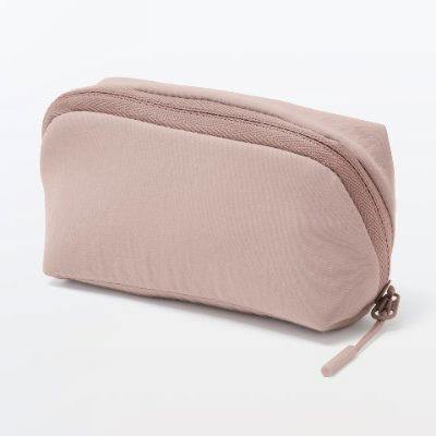 Compact nylon pouch in light pink-beige with a top zipper shown on a white background.