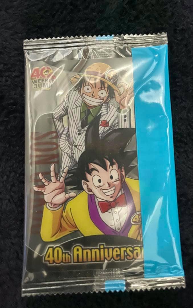 Sealed photocard wafer pack front showing Monkey D. Luffy and Son Goku artwork with "40th Anniversary" text.